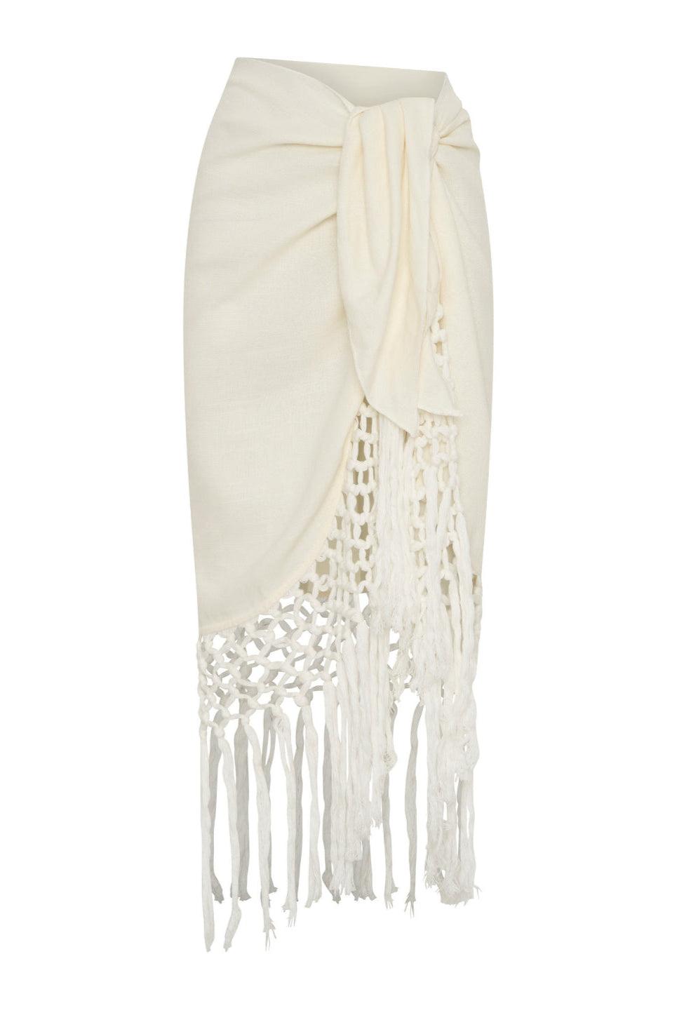 A beige beach cover up sarong with lace detailing and fringes.